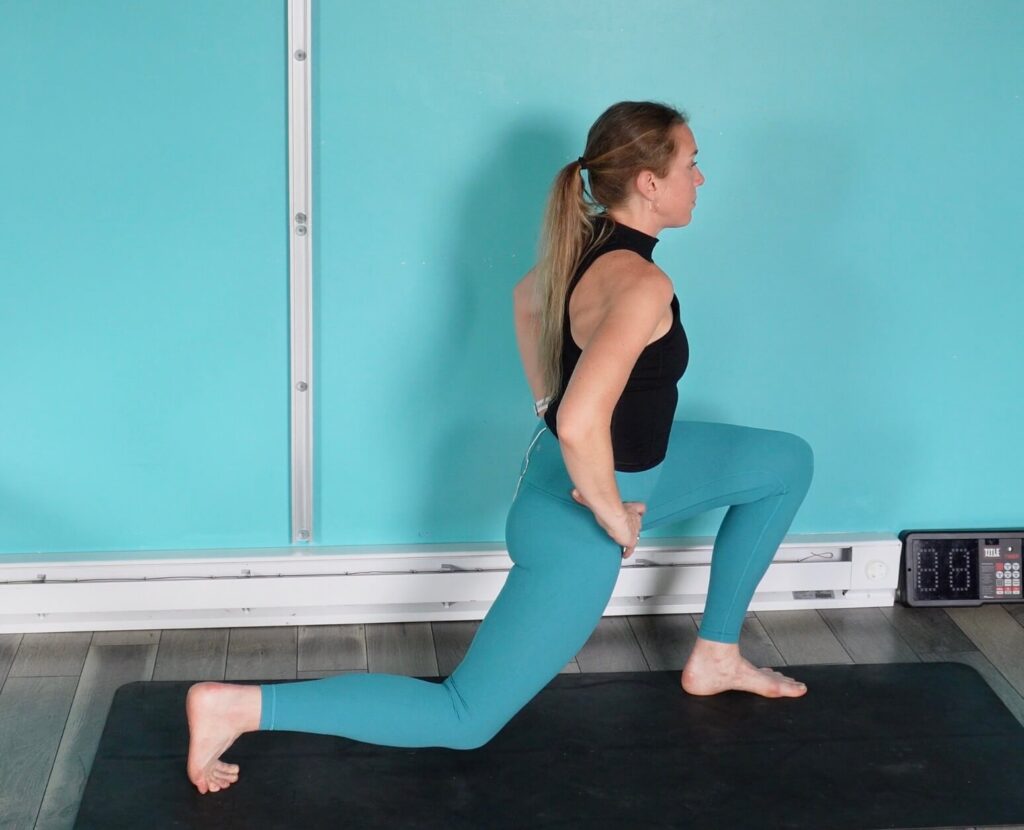 Dr. Chloe bending her front knee for the squat portion of the split squat.